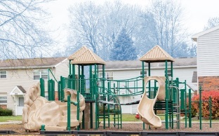 Elmdale Court Playground, green and tan with slide in community
